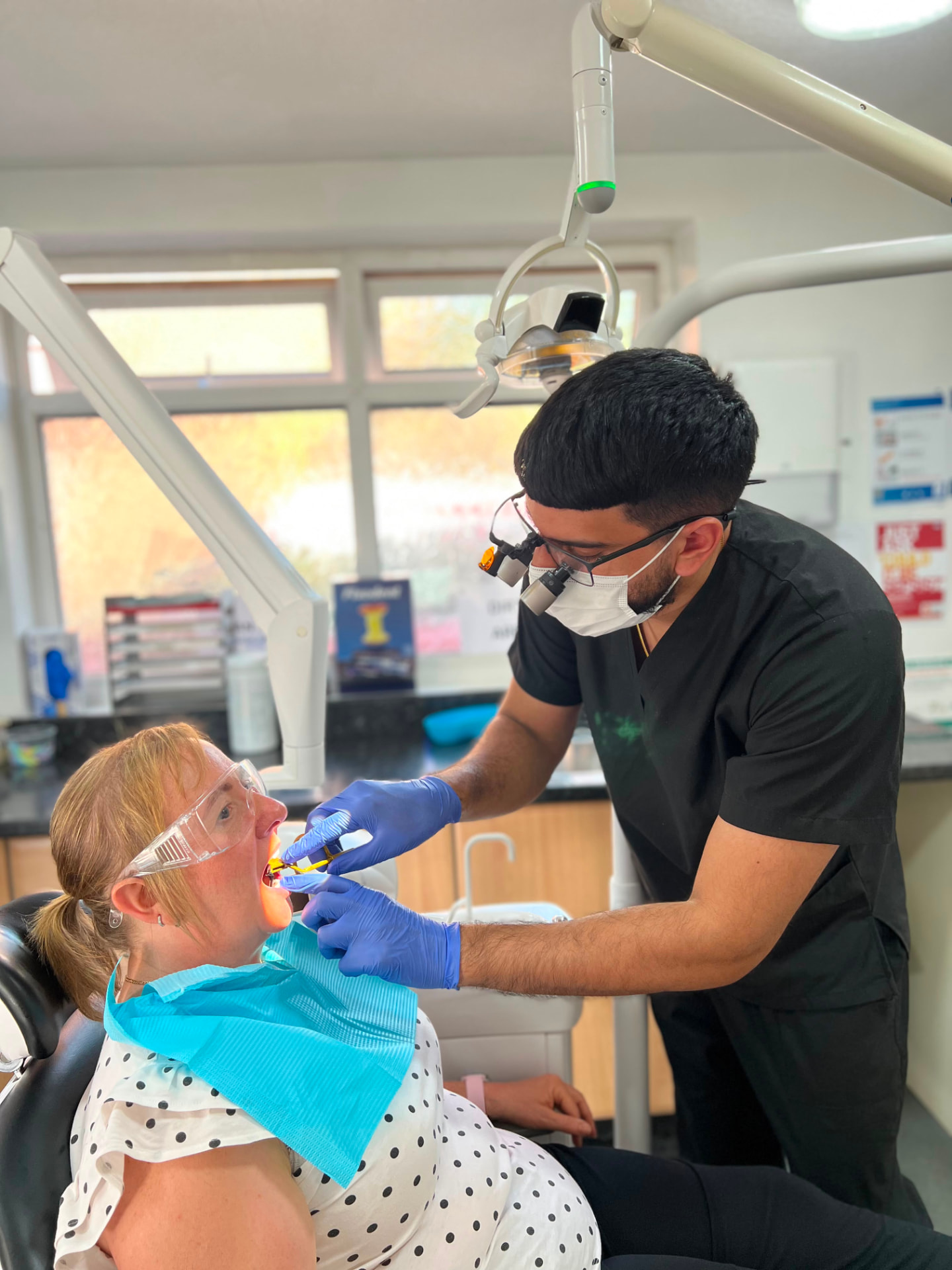 Dentist carrying out treatment at Wolverhampton Dental
